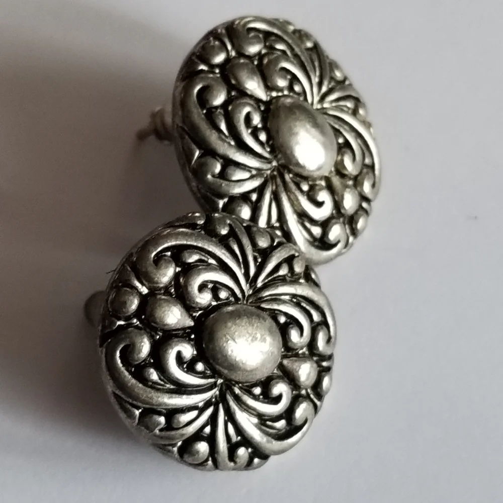 Earrings Silver tone earrings oval stud scrolled design